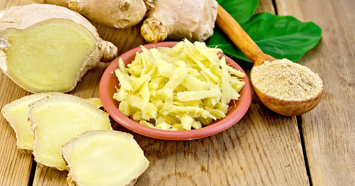 Fresh ginger slices on cutting board.